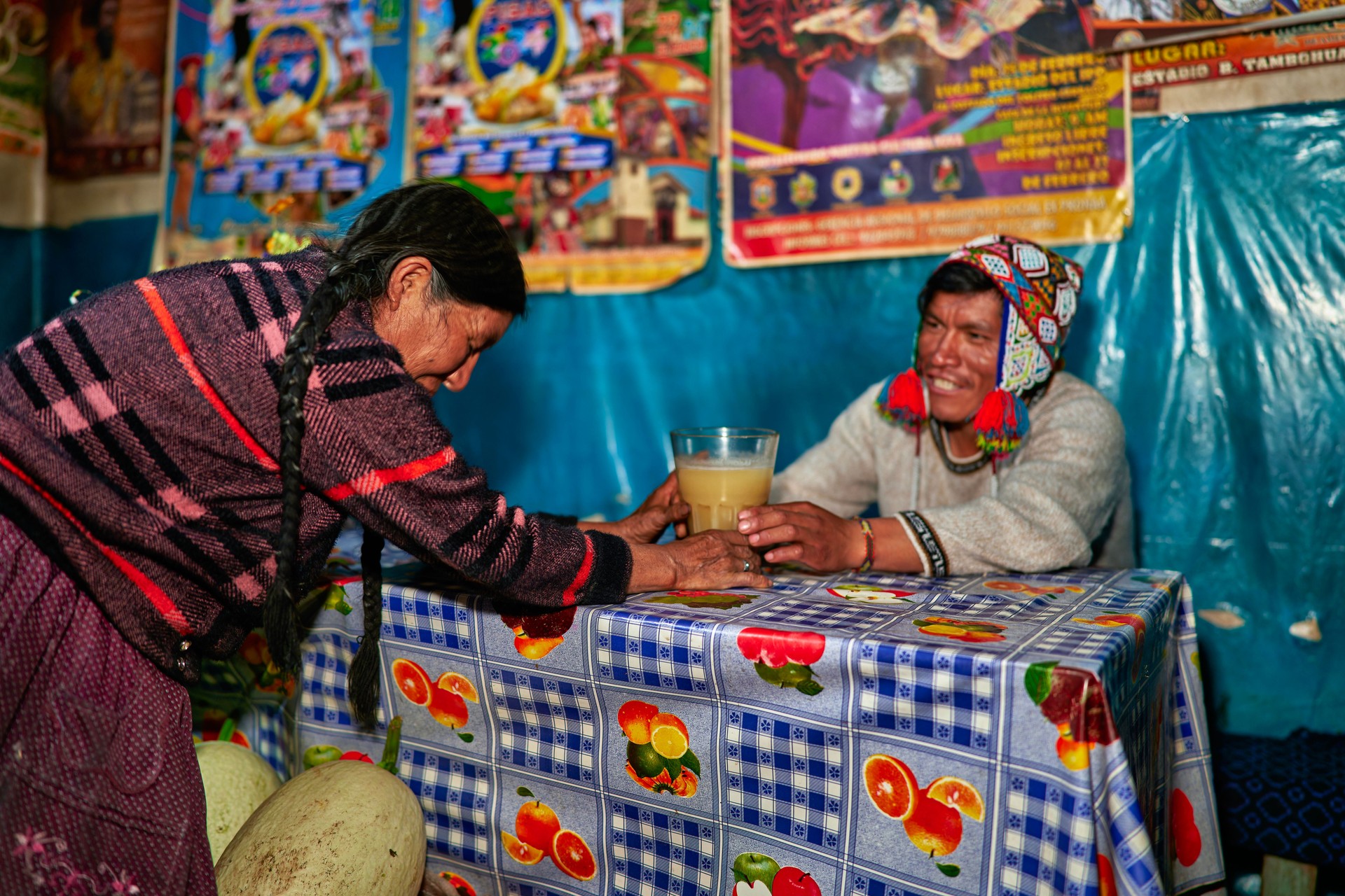 A Peruvian lady of the Quechua ethnic group serves the drink called chicha in a typical chicheria in Pisac in the Cusco region
